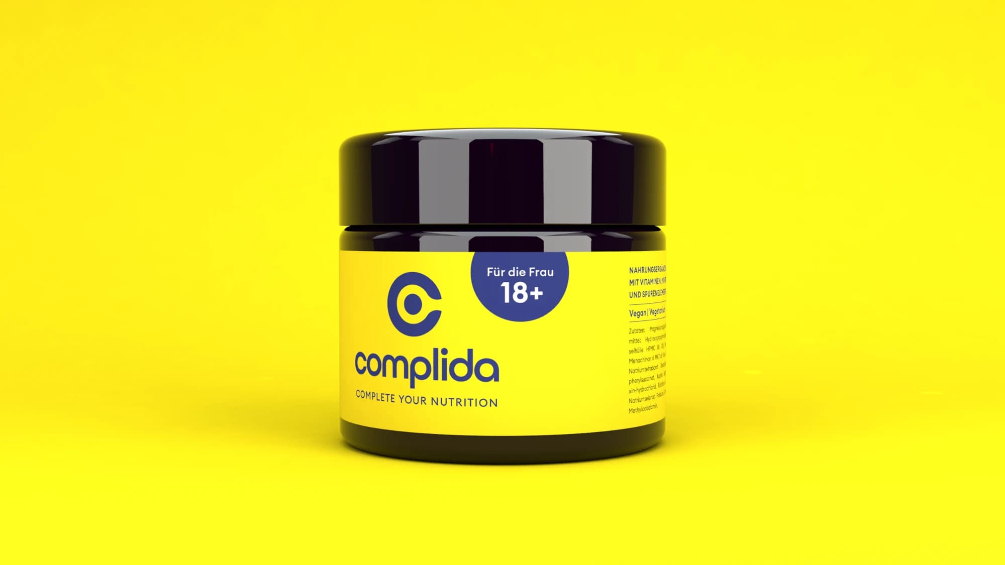 A dark glass jar with a yellow Complida label, rendered on a yellow ground.